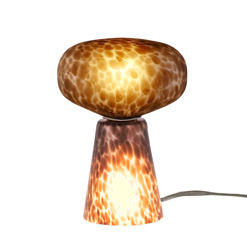 Lampe décorative en verre, la base conique et le dôme sont allumés.