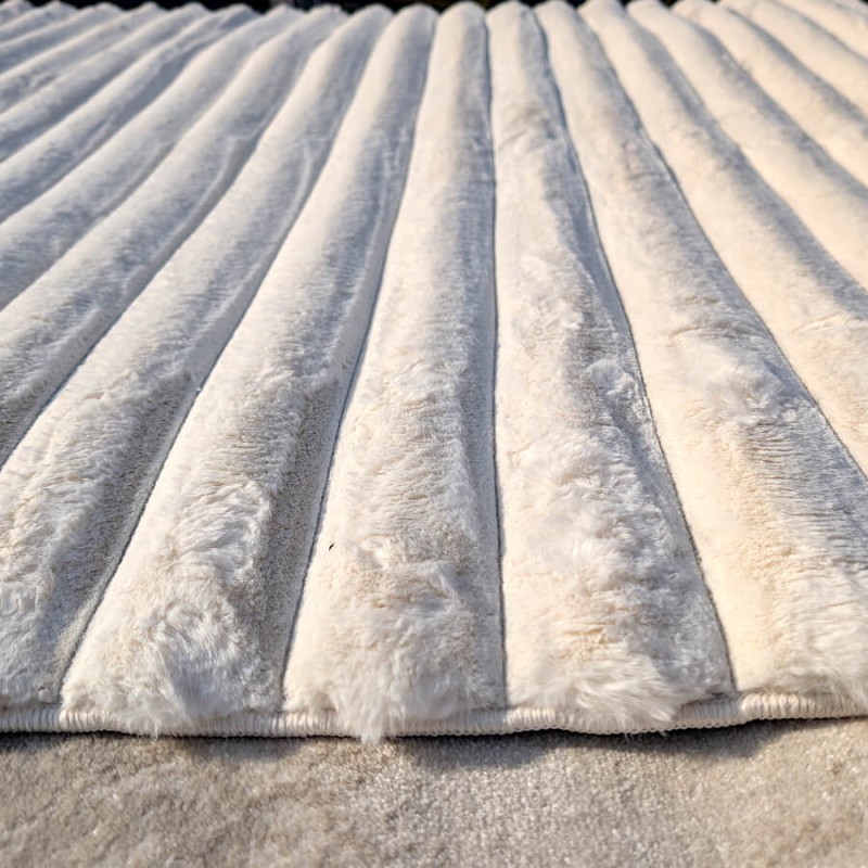 Gros plan sur les lignes en relief et la densité du tissage effet "cocon".