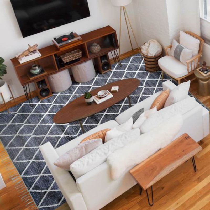 Vue du dessus montrant le grand tapis de salon gris zux losanges en laine écrue, apportant relief et confort à votre chambre.
