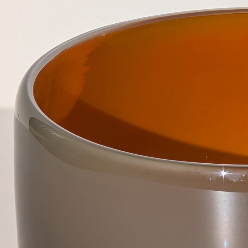 Détail de l'épaisseur du verre solide gris et de la finition intérieure orange effet "lumière de feu".