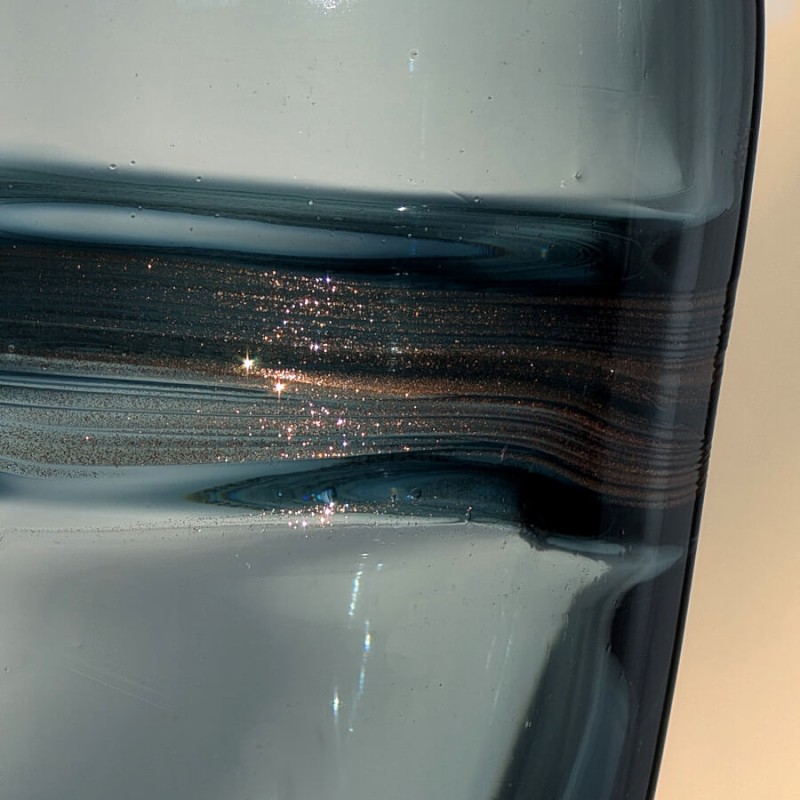 Gros plan sur les paillettes dorées incrustées dans la ceinture centrale.