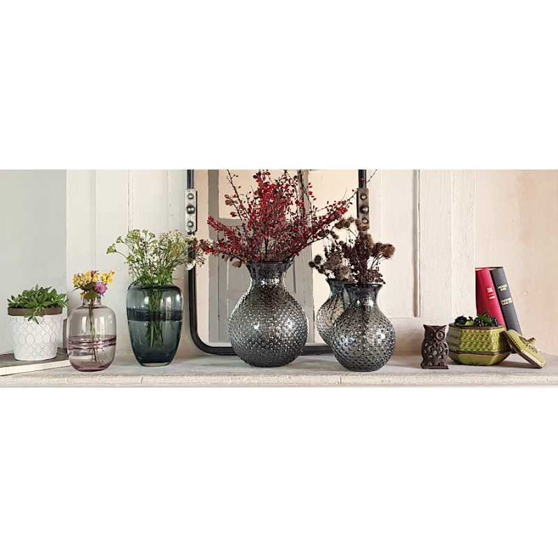 Mise en scène complète intégrant le vase pailleté sur la tablette d'une cheminée en pierre.