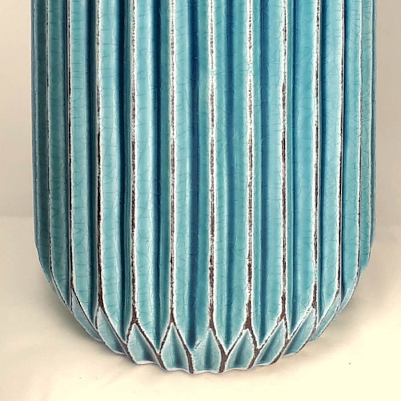 Détail du pied et du plissage régulier sur le bas du vase.