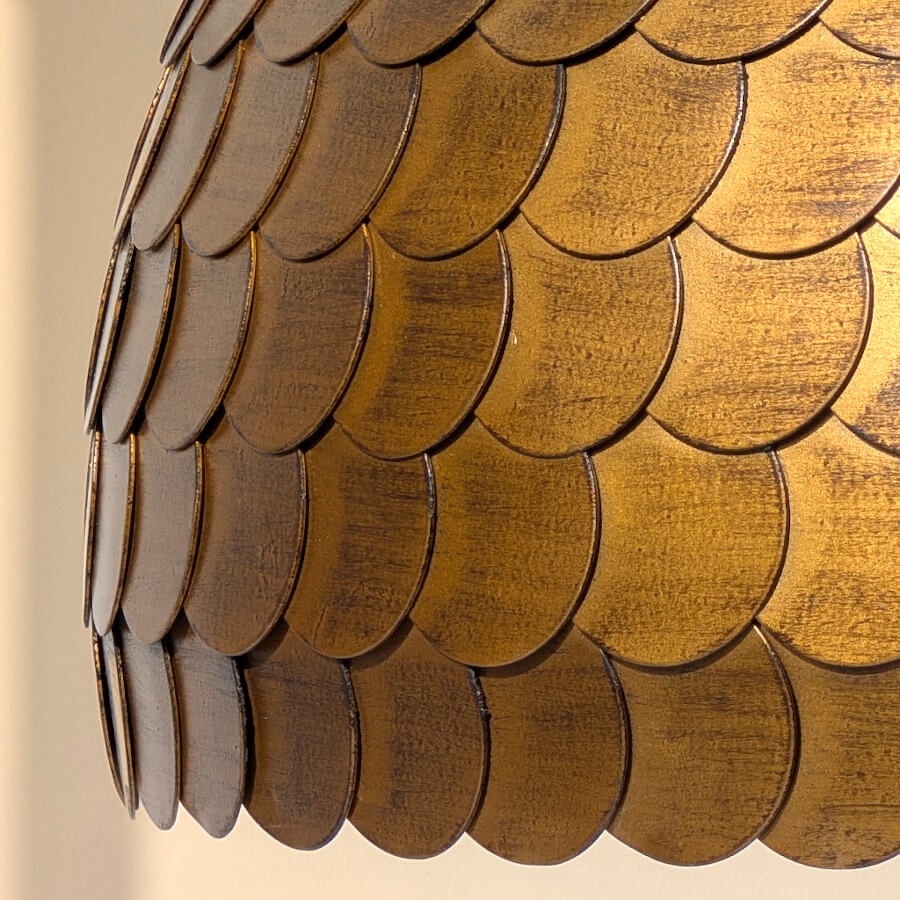 Détail de la finition dorée vieillie et de la patine artisanale.