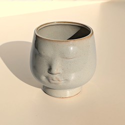 Mise en lumière du visage soulignant la sérénité des traits.