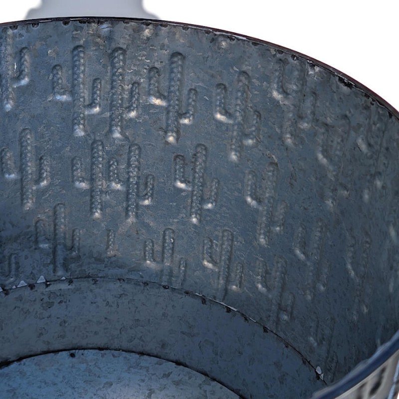 Détail de l'intérieur du pot et de la structure du métal embouti de motifs répétés de cactus.