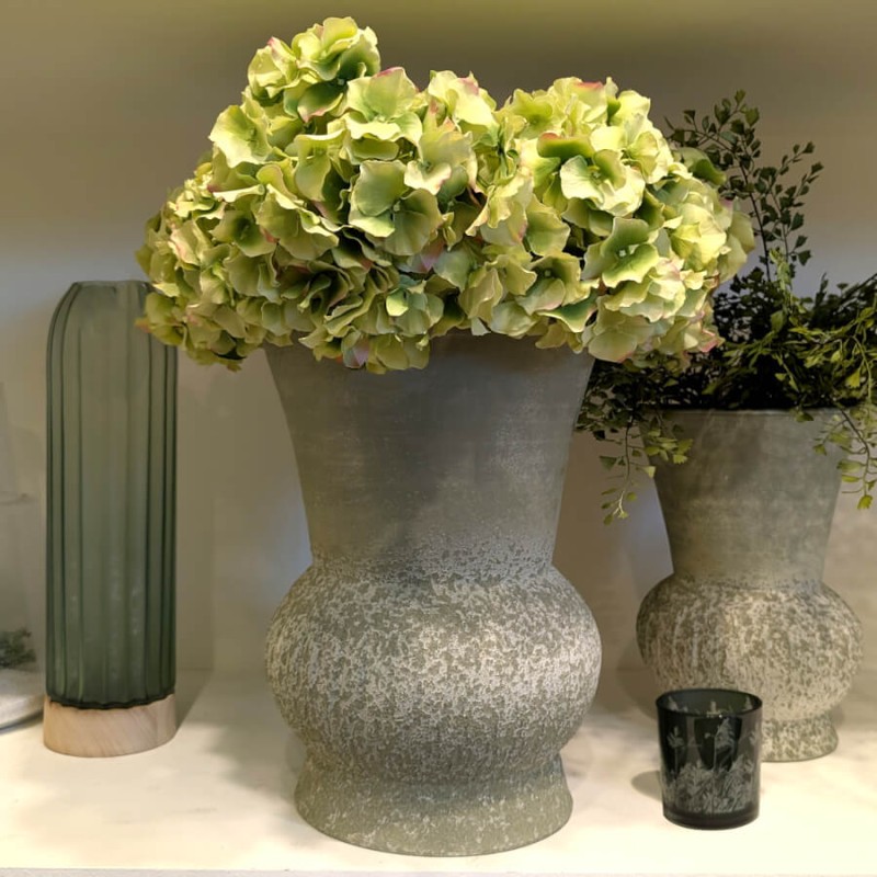 La tige présentée seule dans un grand vase en pierre texturée grise au style minéral.