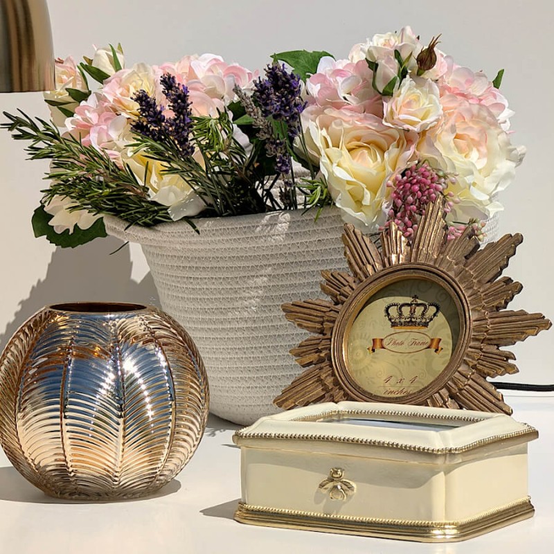 Mise en scène Coiffeuse : Boîte à secrets abeille dorée près d'un vase de fleurs et du miroir soleil Deco-Delight.