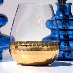 Gros plan sur le photophore en verre goutte et sa partie basse martelée dorée effet nid d'abeille.